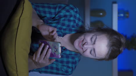 Vertical-video-of-Phone-addicted-woman-at-home-at-night.